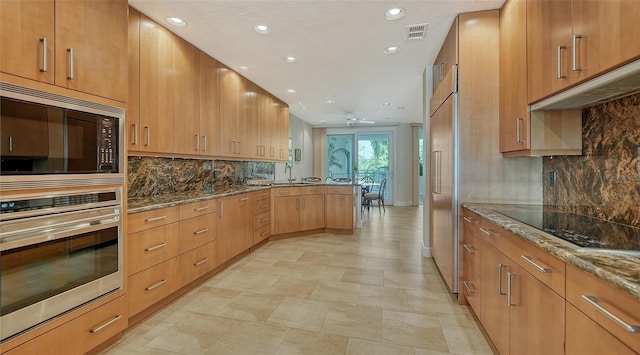 kitchen featuring built in microwave, stainless steel oven, stone countertops, black electric cooktop, and backsplash