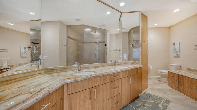 bathroom with tile patterned floors, vanity, toilet, and a shower with shower door