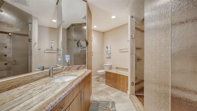 bathroom featuring vanity, an enclosed shower, and toilet