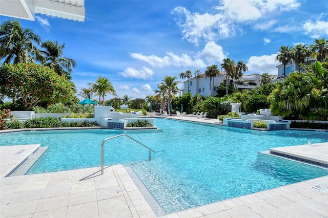 view of swimming pool with pool water feature