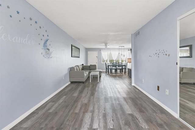 unfurnished living room featuring dark hardwood / wood-style flooring and ceiling fan