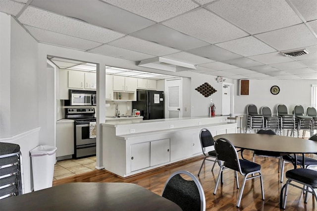 dining area with light hardwood / wood-style floors and sink