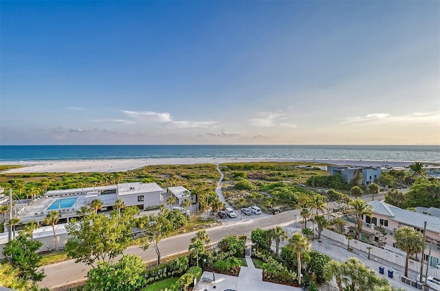 drone / aerial view featuring a water view and a view of the beach