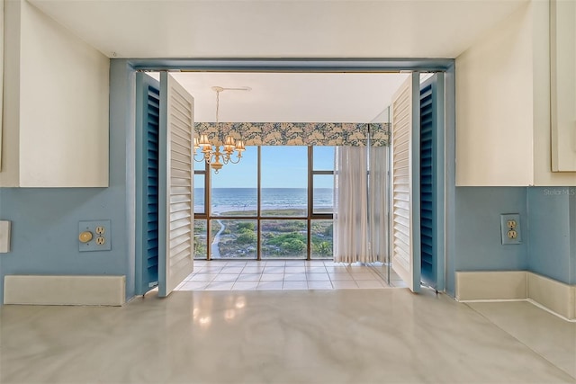 interior space with a water view, expansive windows, and a chandelier