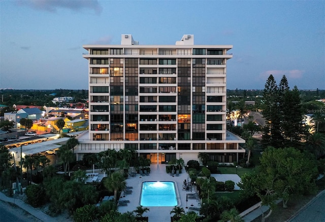 outdoor building at dusk with a community pool