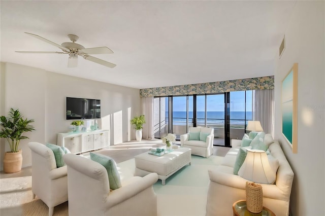 living room with ceiling fan and plenty of natural light