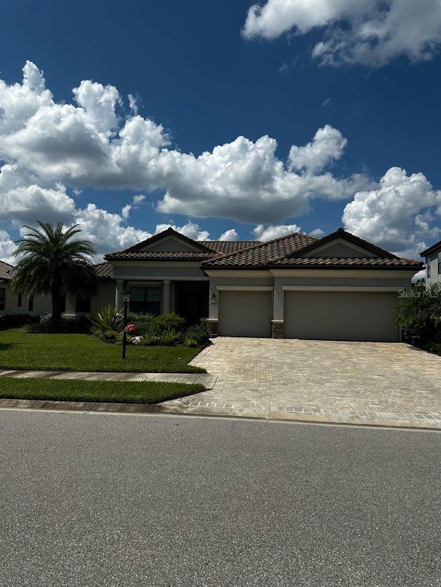 view of front of property featuring a garage and a front lawn