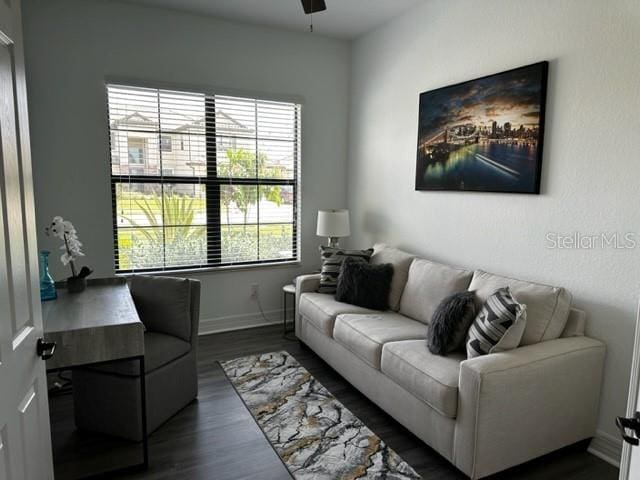 living room with dark hardwood / wood-style floors and ceiling fan