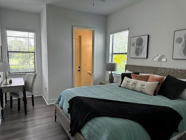 bedroom featuring ensuite bathroom and hardwood / wood-style flooring