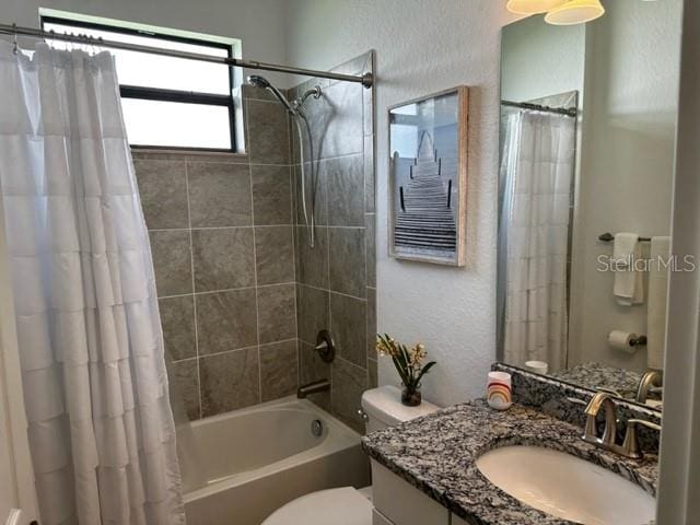 full bathroom featuring toilet, vanity, and shower / tub combo with curtain