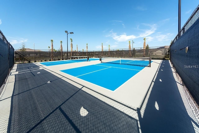 view of pool featuring tennis court