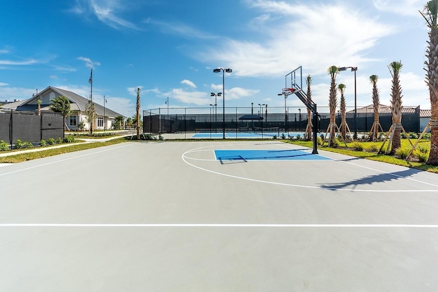 view of sport court featuring tennis court