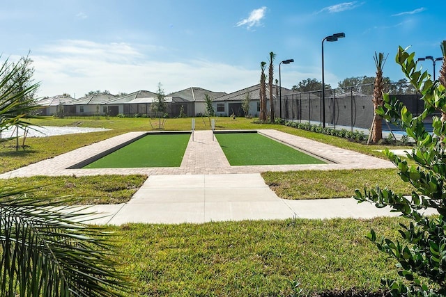 view of property's community featuring a yard