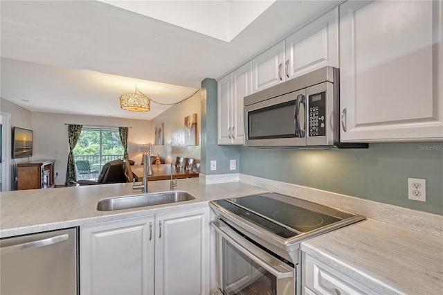 kitchen featuring appliances with stainless steel finishes, sink, and white cabinets