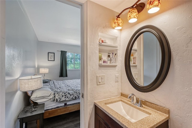 bathroom featuring hardwood / wood-style flooring and vanity