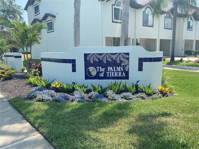 community / neighborhood sign with a lawn