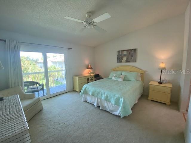 bedroom featuring ceiling fan, carpet floors, a textured ceiling, access to outside, and lofted ceiling