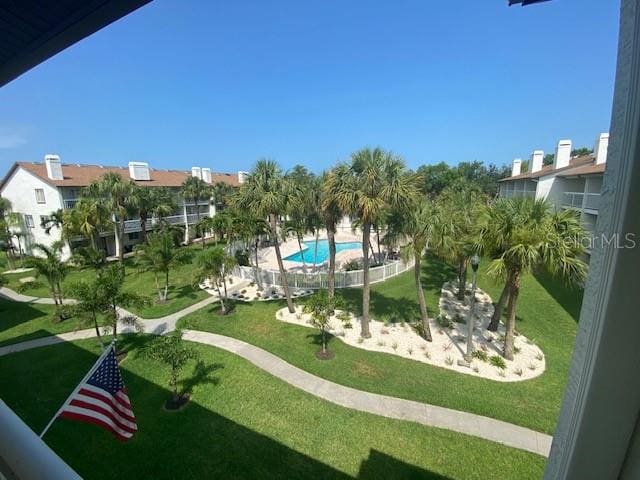 view of nearby features featuring a pool and a lawn