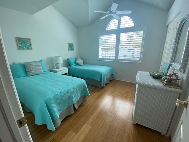 bedroom featuring vaulted ceiling, wood-type flooring, and ceiling fan