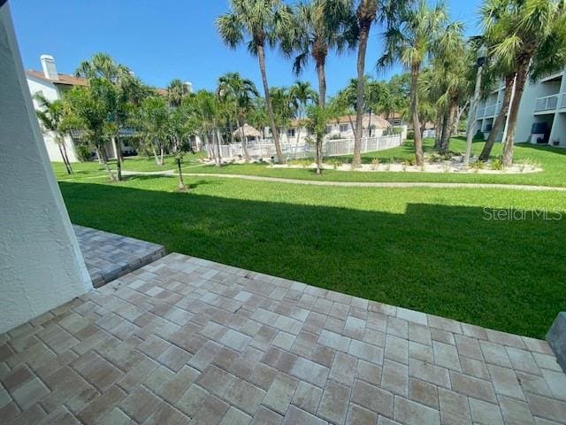 view of home's community with a patio and a lawn