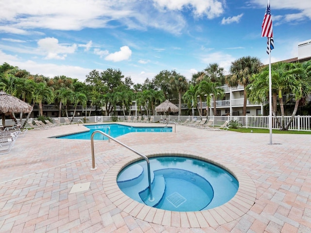 view of pool with a community hot tub and a patio