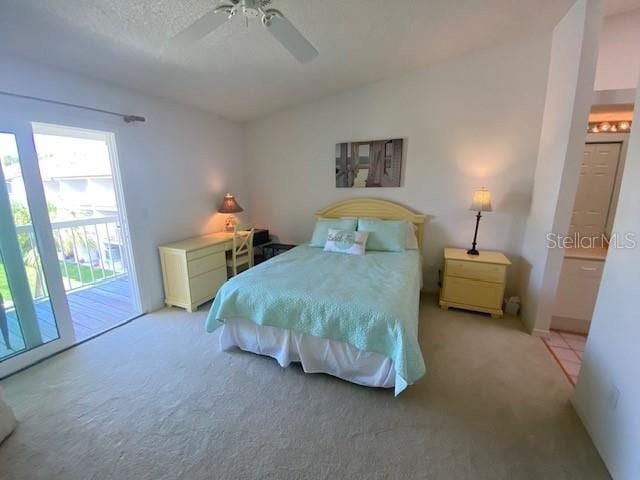 carpeted bedroom featuring lofted ceiling, access to outside, and a ceiling fan