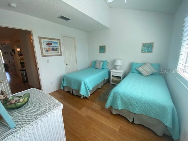 bedroom featuring visible vents and wood finished floors