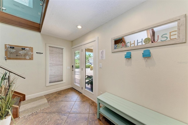 tiled entrance foyer with a textured ceiling