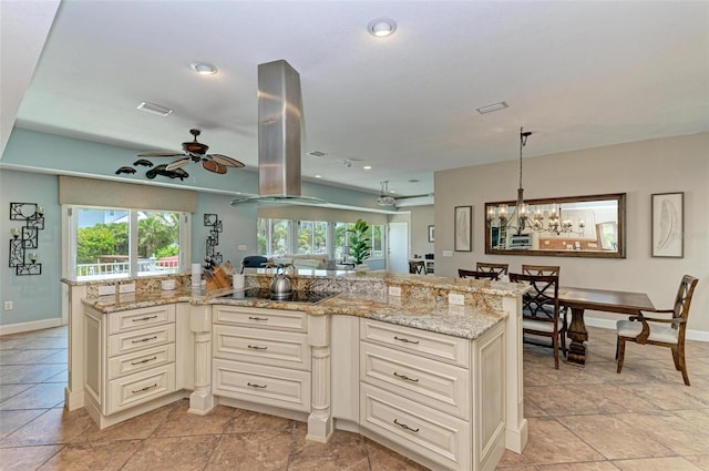 kitchen with range hood, light stone countertops, light tile flooring, and ceiling fan with notable chandelier