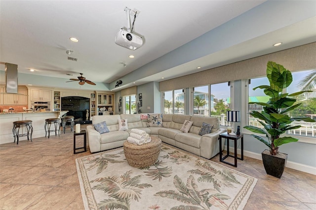 living room with ceiling fan and light tile flooring