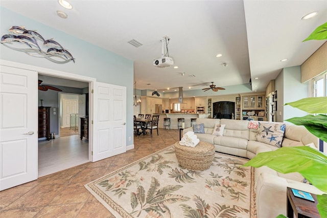 living room with tile floors and ceiling fan