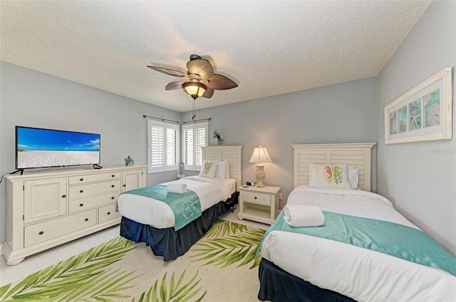 bedroom featuring ceiling fan and a textured ceiling