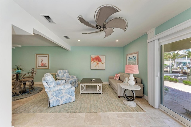 tiled living room with beamed ceiling and ceiling fan