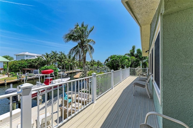 deck with a water view and a dock