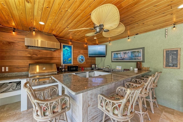 kitchen featuring wooden ceiling, kitchen peninsula, and a kitchen bar