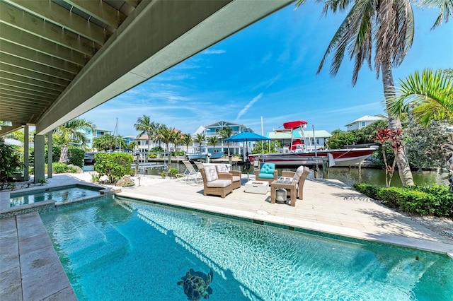 view of swimming pool featuring a water view and a patio