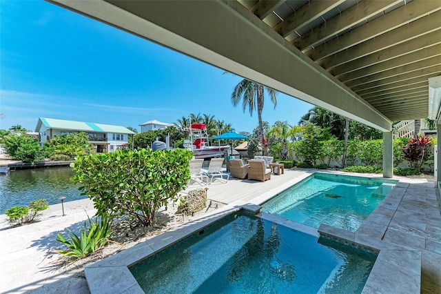 view of swimming pool with a patio area and an in ground hot tub