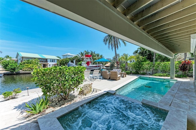 view of pool featuring a patio area and an in ground hot tub