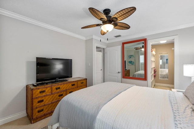 carpeted bedroom with connected bathroom, ceiling fan, and crown molding