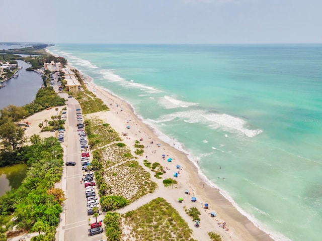 birds eye view of property featuring a beach view and a water view