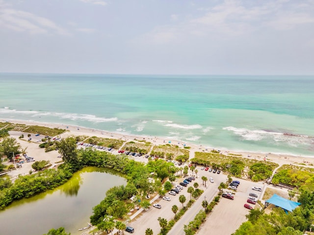 birds eye view of property featuring a view of the beach and a water view