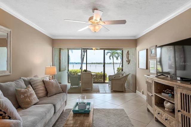 living room featuring ceiling fan, crown molding, a water view, a textured ceiling, and tile floors