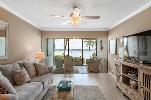 living room with crown molding, ceiling fan, a water view, and tile floors