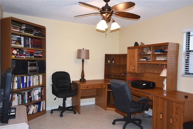 office area with a textured ceiling, ceiling fan, and light tile floors