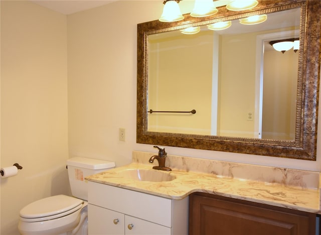 bathroom with vanity with extensive cabinet space and toilet