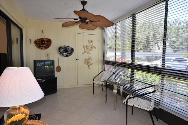 sunroom / solarium featuring ceiling fan