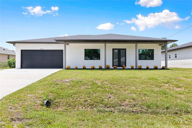 view of front of house with stucco siding, french doors, concrete driveway, a front yard, and a garage