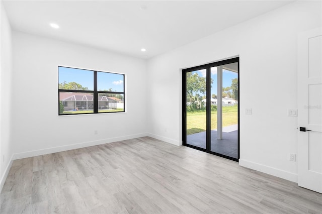 empty room with light hardwood / wood-style floors