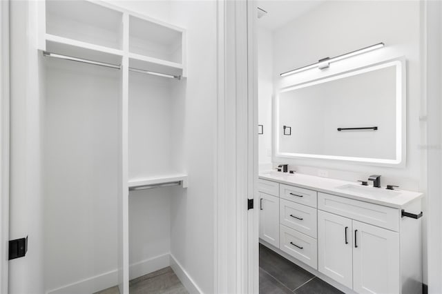 bathroom with dual bowl vanity and tile patterned floors