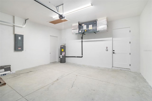 garage with electric panel, a garage door opener, and water heater